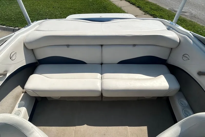 Slide: The Image of 2003 Crownline 192 BR boat interior with white cushioned seating and cup holders. - 17