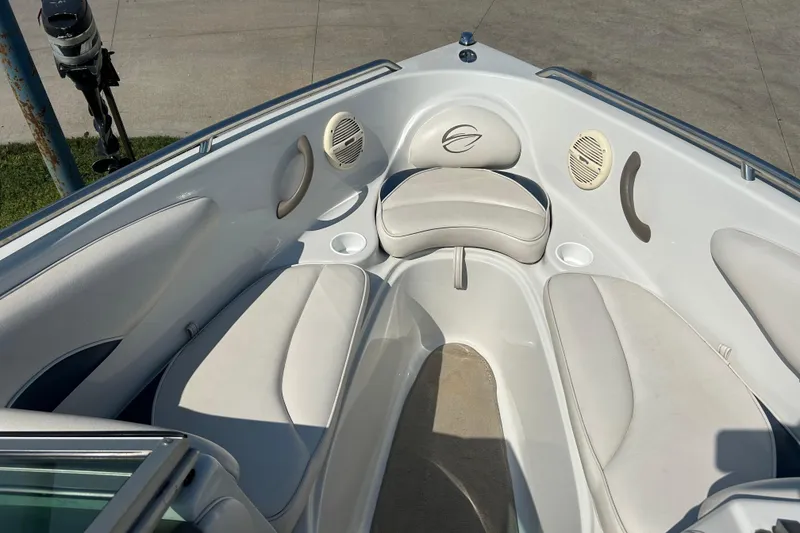 Slide: The Image of 2003 Crownline 192 BR boat interior with white seating and cup holders. - 9