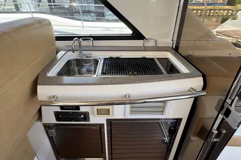 Slide: The Image of 2010 Regal 44 Sport Coupe yacht kitchenette with sink and grill. - 10