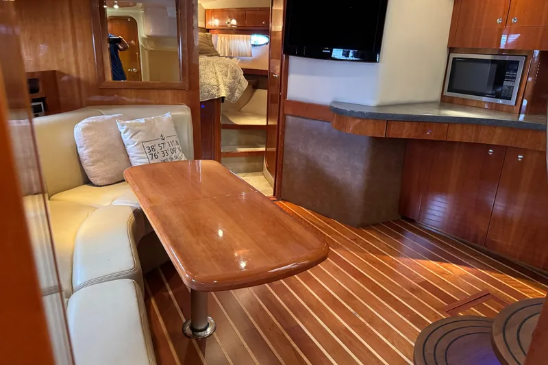 Slide: The Image of Luxurious interior of a 2010 Regal 44 Sport Coupe yacht with wood finishes and modern amenities. - 16