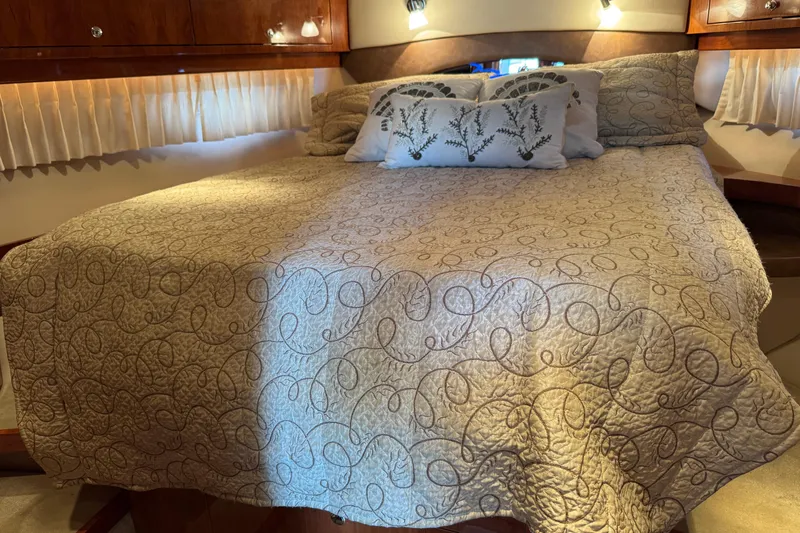 Slide: The Image of Luxurious bedroom interior of 2010 Regal 44 Sport Coupe yacht with elegant bedding. - 22