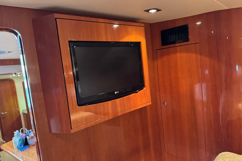 Slide: The Image of Interior of 2010 Regal 44 Sport Coupe with mounted TV and wooden paneling. - 23