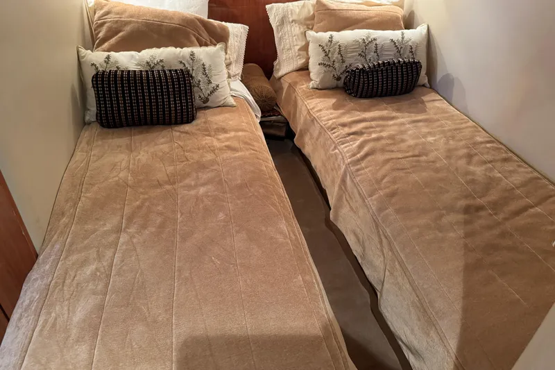 Slide: The Image of Interior of 2010 Regal 44 Sport Coupe with twin beds and decorative pillows. - 29