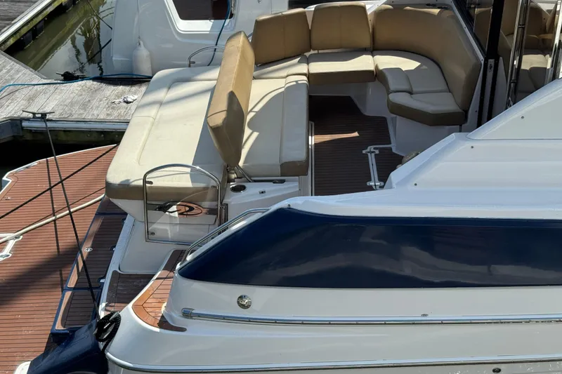 Slide: The Image of 2010 Regal 44 Sport Coupe yacht with spacious deck seating at the marina. - 3