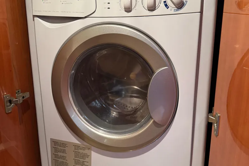 Slide: The Image of Front-loading washing machine inside a 2010 Regal 44 Sport Coupe yacht. - 32