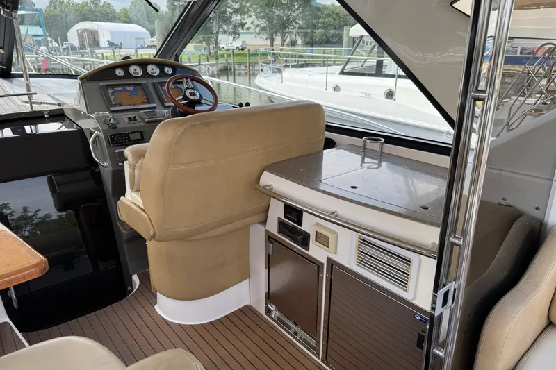 Slide: The Image of 2010 Regal 44 Sport Coupe interior with helm, navigation, and seating area. - 9