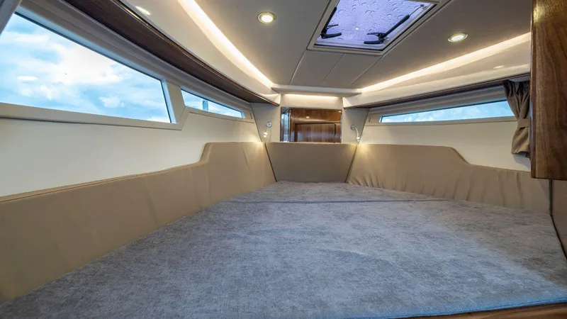 Slide: The Image of Luxurious interior cabin of 2025 Aquador 300 HT boat with modern lighting and windows. - 16