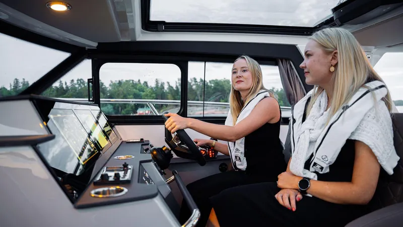 Slide: The Image of Two women inside a 2025 Aquador 300 HT boat, enjoying a scenic ride. - 21