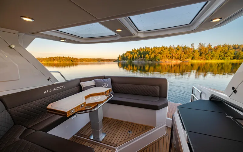 Slide: The Image of Luxurious 2025 Aquador 300 HT yacht interior with scenic lake view at sunset. - 25