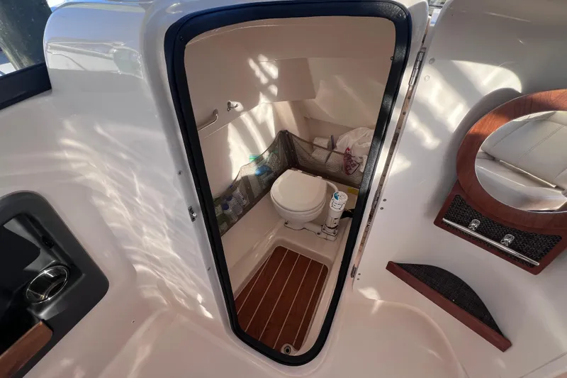 Slide: The Image of Interior of 2015 Grady White 255 Freedom boat showing compact marine toilet. - 4