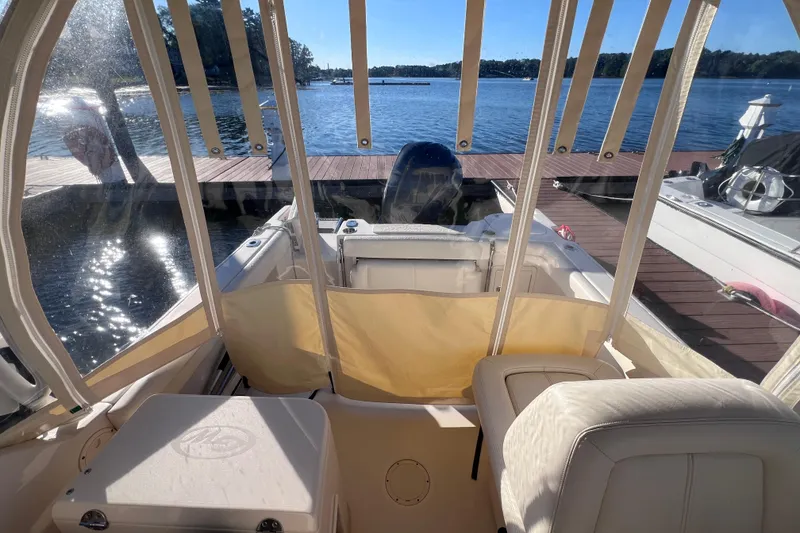 Slide: The Image of 2015 Grady White 255 Freedom boat interior with lake view and docked surroundings. - 5