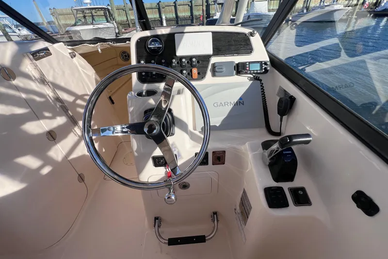 Slide: The Image of Steering console of 2015 Grady White 255 Freedom boat with Garmin navigation system. - 7