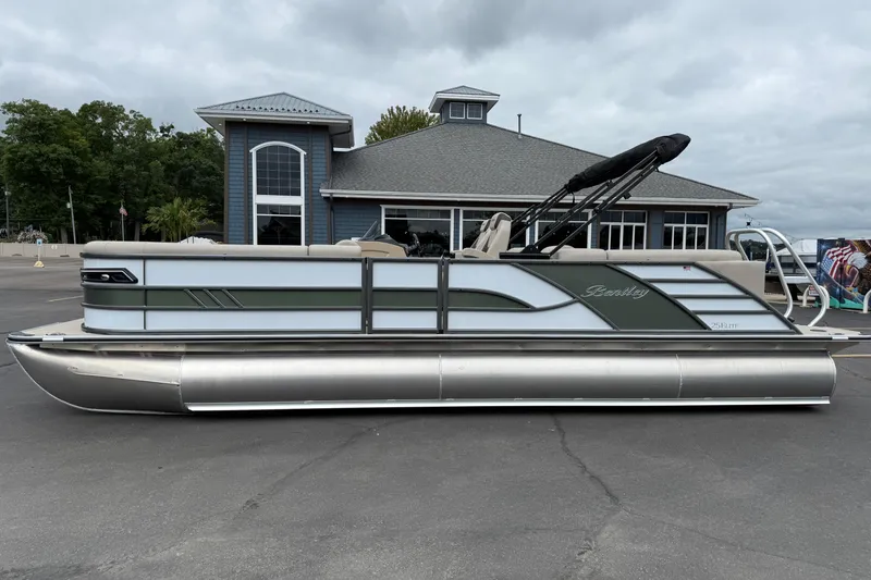 The Image of 2026 Bentley Pontoons Elite 253 Admiral pontoon boat parked outside a building. - 1