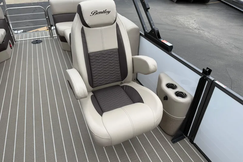 Slide: The Image of 2026 Bentley Pontoons Elite 253 Admiral interior with luxurious captain's chair and cup holders. - 19