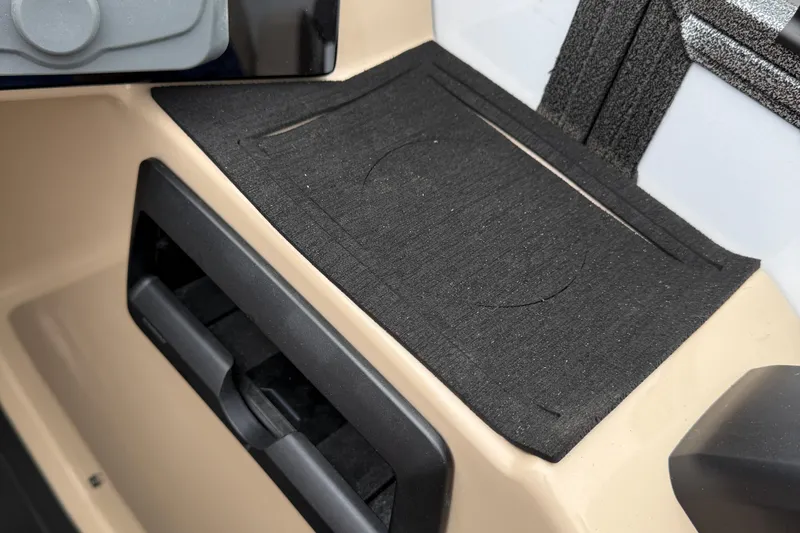 Slide: The Image of 2026 Bentley Pontoons Elite 253 Admiral interior detail with black mat and beige paneling. - 27