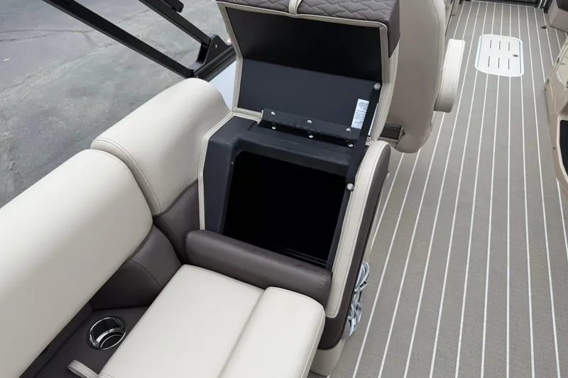 Slide: The Image of 2026 Bentley Pontoons Elite 253 Admiral interior storage compartment with beige seating and striped flooring. - 33