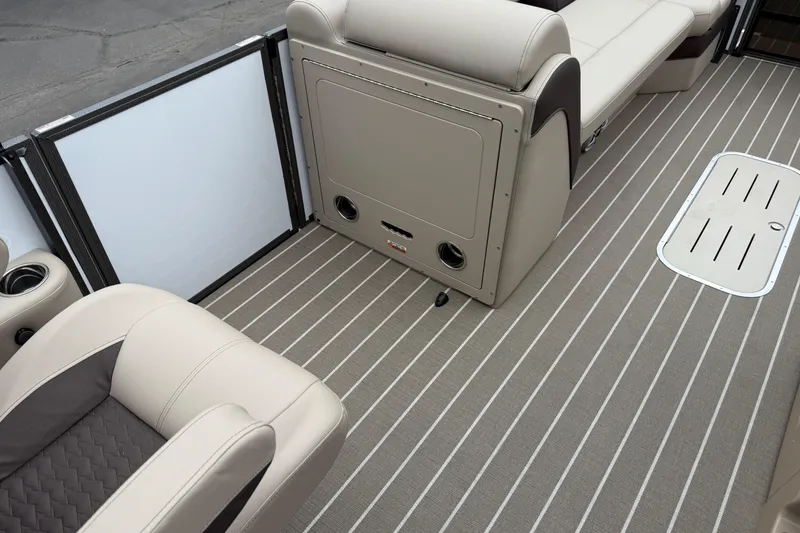 Slide: The Image of 2026 Bentley Pontoons Elite 253 Admiral interior with beige seating and striped flooring. - 36