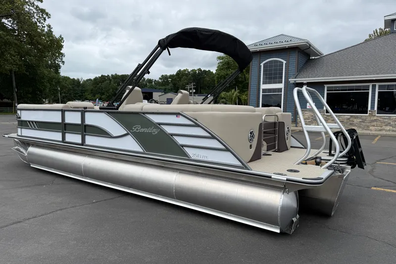 Slide: The Image of 2026 Bentley Pontoons Elite 253 Admiral pontoon boat parked outside a building. - 4