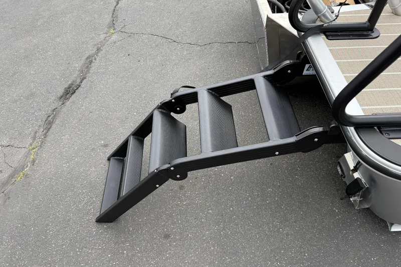 Slide: The Image of 2026 Bentley Pontoons Elite 253 Admiral with extended boarding ladder on pavement. - 6