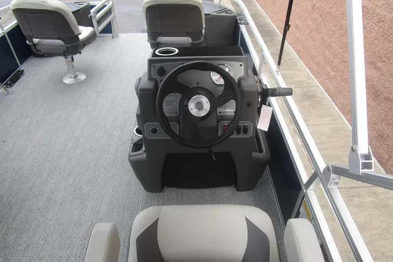 Slide: The Image of 2026 Sun Tracker Bass Buggy 18 DLX interior with steering console and seating. - 10