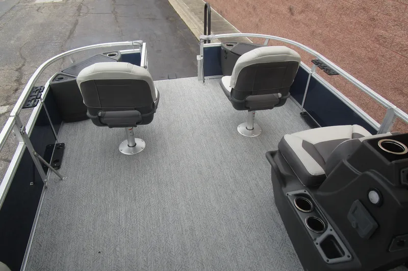 Slide: The Image of 2026 Sun Tracker Bass Buggy 18 DLX pontoon boat interior with seating and console. - 11