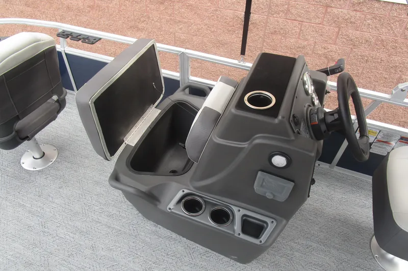 Slide: The Image of 2026 Sun Tracker Bass Buggy 18 DLX boat console with steering wheel and storage compartment. - 13