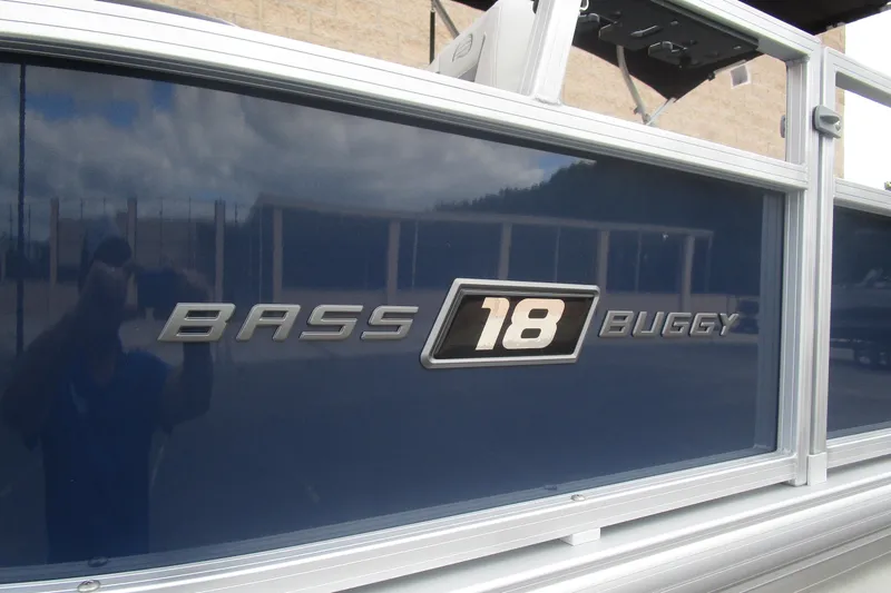Slide: The Image of 2026 Sun Tracker Bass Buggy 18 DLX logo on blue boat exterior. - 3