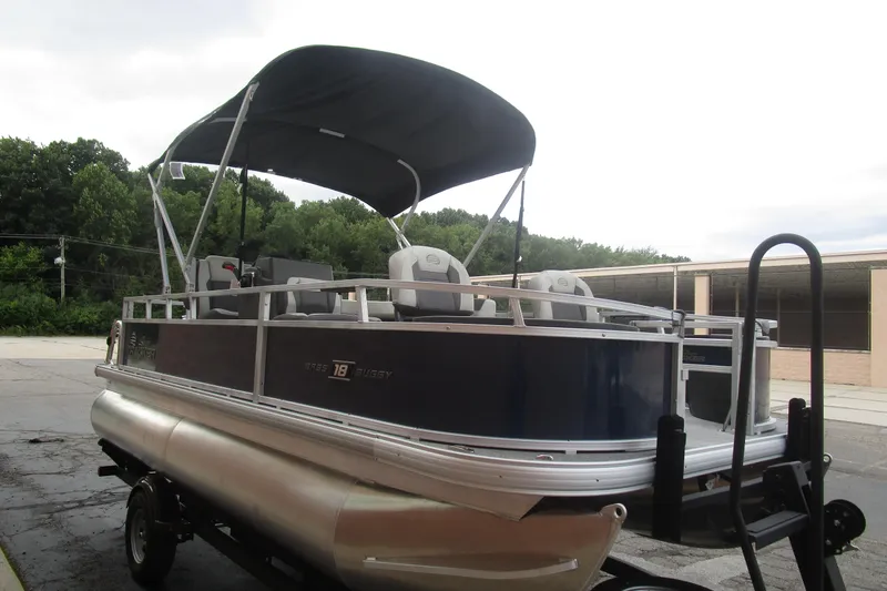 Slide: The Image of 2026 Sun Tracker Bass Buggy 18 DLX pontoon boat with canopy on trailer. - 5