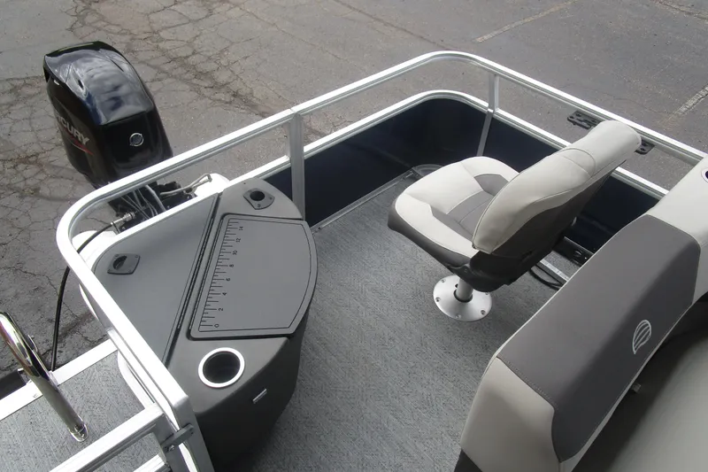 Slide: The Image of 2026 Sun Tracker Bass Buggy 18 DLX pontoon boat interior with seating and Mercury outboard motor. - 7
