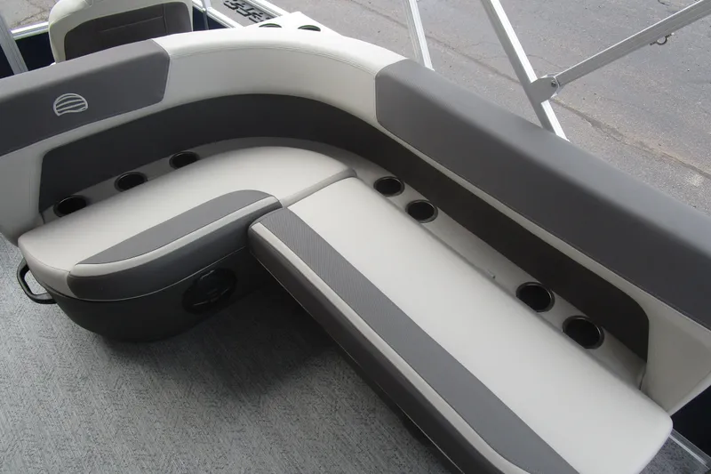 Slide: The Image of 2026 Sun Tracker Bass Buggy 18 DLX boat seating with cup holders, gray and white upholstery. - 8