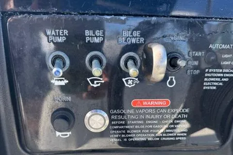 Slide: The Image of Control panel of a 2009 Sea Ray 230 Sundeck boat with switches and warning label. - 10