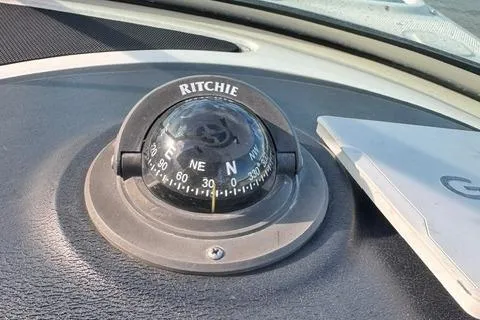 Slide: The Image of Compass on 2009 Sea Ray 230 Sundeck dashboard, showing cardinal directions. - 12