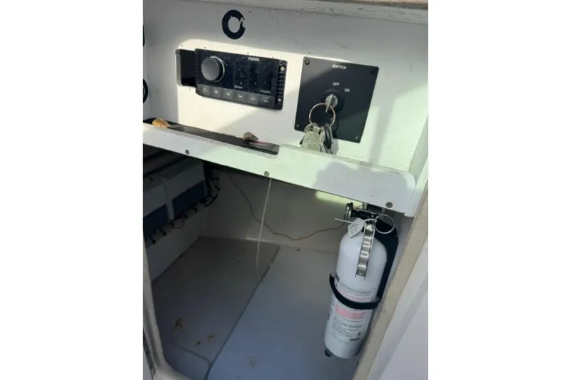Slide: The Image of Control panel and fire extinguisher inside 2009 Sea Ray 230 Sundeck boat. - 13