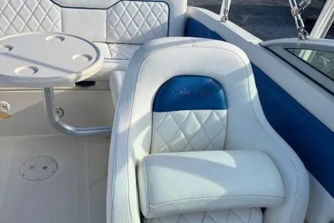 Slide: The Image of 2009 Sea Ray 230 Sundeck interior with white seating and table. - 15