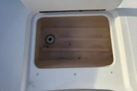 Slide: The Image of 2009 Sea Ray 230 Sundeck storage compartment, open and empty. - 17