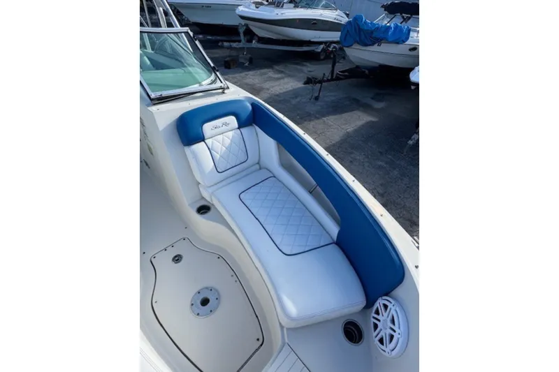 Slide: The Image of 2009 Sea Ray 230 Sundeck boat interior with blue and white seating. - 21