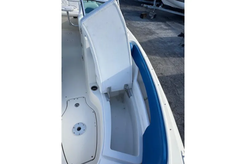 Slide: The Image of 2009 Sea Ray 230 Sundeck boat interior with open storage compartment. - 22
