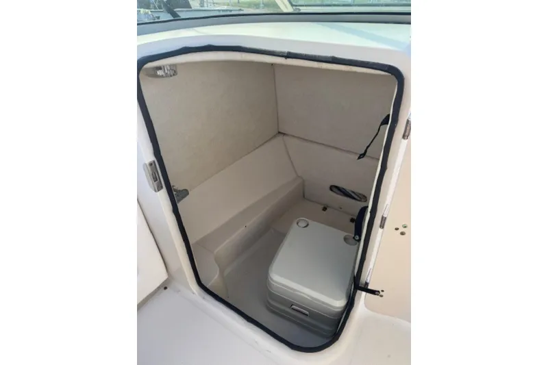 Slide: The Image of 2009 Sea Ray 230 Sundeck interior with compact marine toilet. - 26