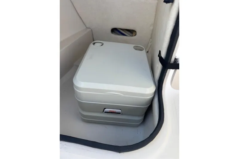 Slide: The Image of Portable toilet inside 2009 Sea Ray 230 Sundeck boat compartment. - 27