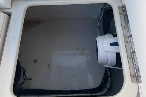 Slide: The Image of Storage compartment of 2009 Sea Ray 230 Sundeck boat, featuring a white interior. - 28