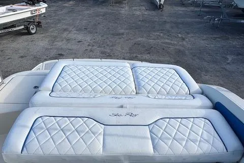 Slide: The Image of 2009 Sea Ray 230 Sundeck boat with white quilted seating. - 33
