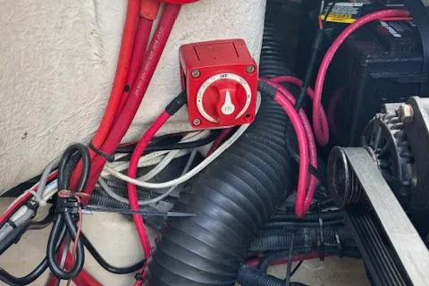 Slide: The Image of 2009 Sea Ray 230 Sundeck engine compartment with red battery switch and wiring. - 39