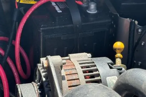 Slide: The Image of Close-up of a 2009 Sea Ray 230 Sundeck engine with visible battery and cables. - 41