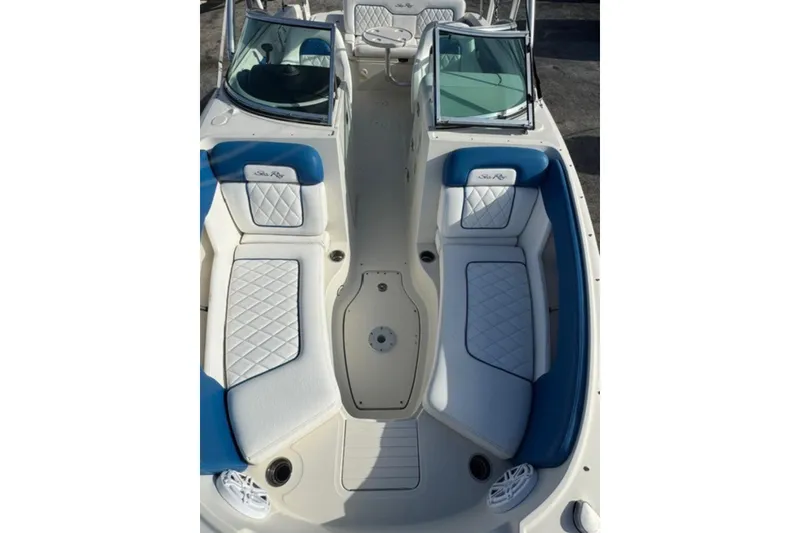 Slide: The Image of 2009 Sea Ray 230 Sundeck boat interior with blue and white seating. - 5