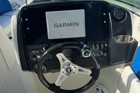 Slide: The Image of 2009 Sea Ray 230 Sundeck dashboard with Garmin navigation system and steering wheel. - 8