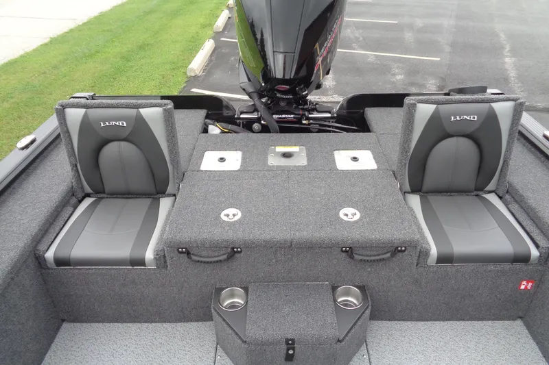 Slide: The Image of 2026 Lund 2075 Pro-V Bass XS boat interior with storage compartments and cup holders. - 10