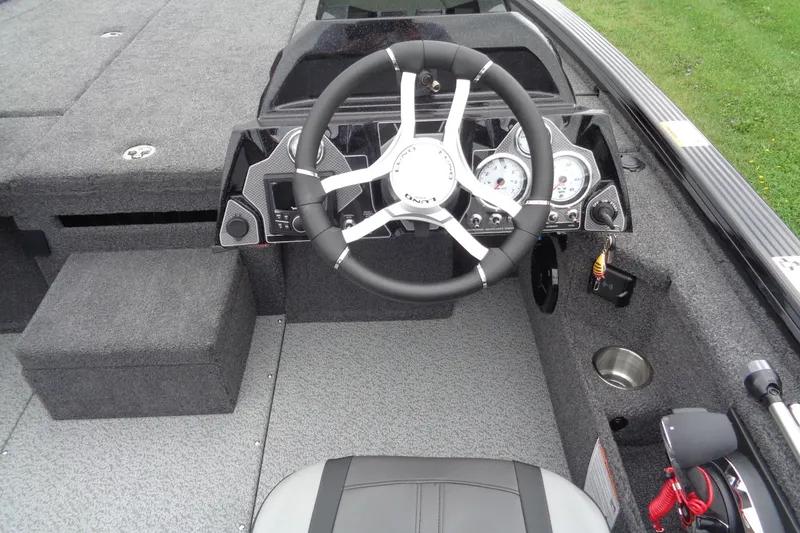 Slide: The Image of 2026 Lund 2075 Pro-V Bass XS boat interior with dual seats and motor view. - 11