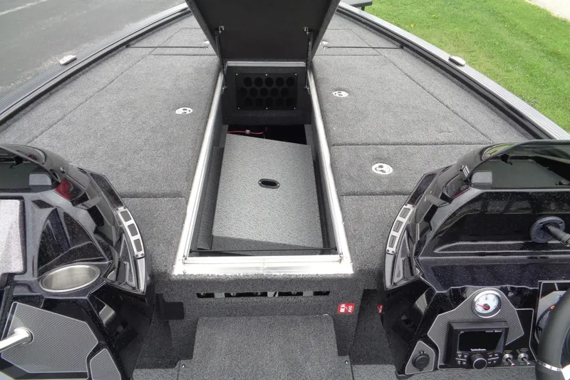Slide: The Image of 2026 Lund 2075 Pro-V Bass XS boat deck with carpeted surface and storage compartments. - 18