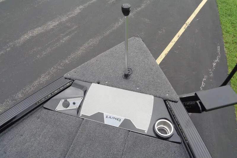 Slide: The Image of 2026 Lund 2075 Pro-V Bass XS boat interior with open storage compartment and dual consoles. - 19