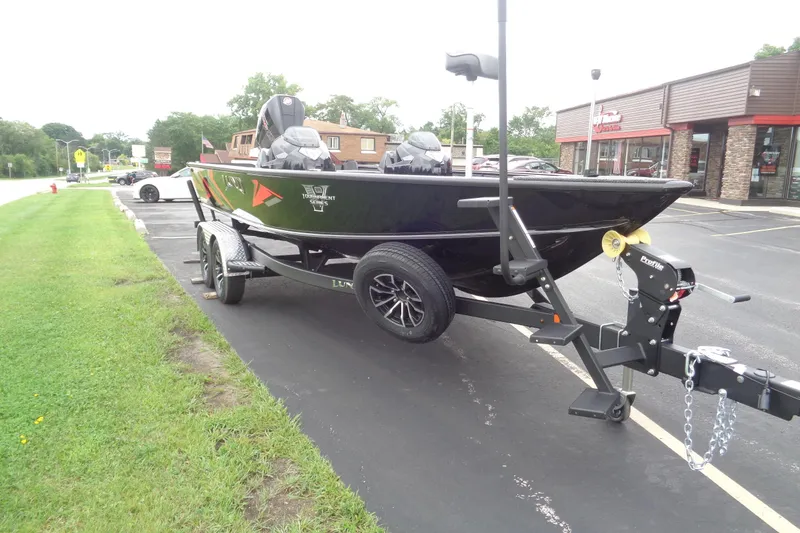 Slide: The Image of 2026 Lund 2075 Pro-V Bass XS boat on trailer, parked outside dealership. - 7